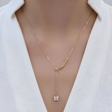 Rose gold necklace with a butterfly pendant on a white background