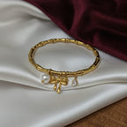 Gold Bamboo Bangle with Pearl Bow & CZ Charms