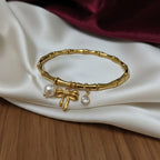 Gold Bamboo Bangle with Pearl Bow & CZ Charms