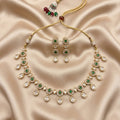 Jewelry set with necklace and earrings on a beige satin background
