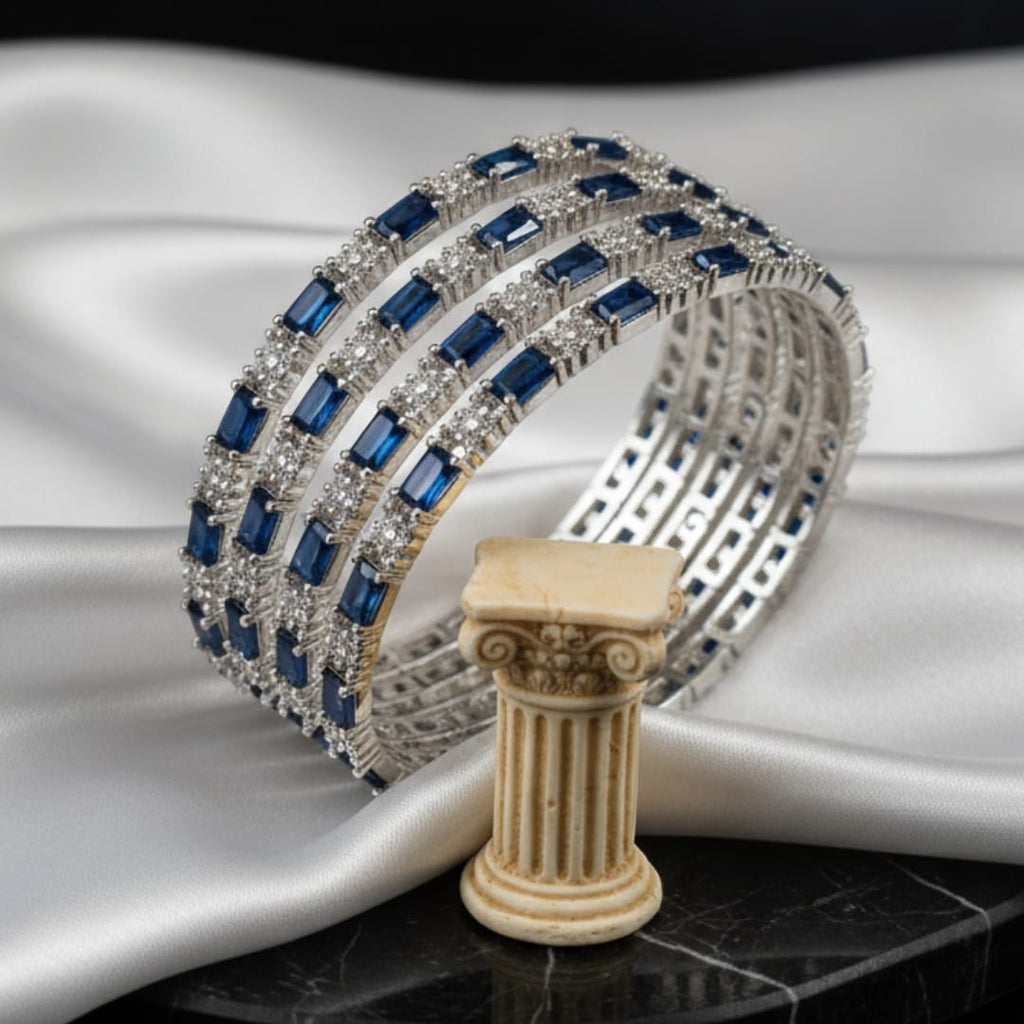 Shinayra by Nakhrali Creation set of 4 blue baguette and round CZ tennis bangles in rhodium silver finish.