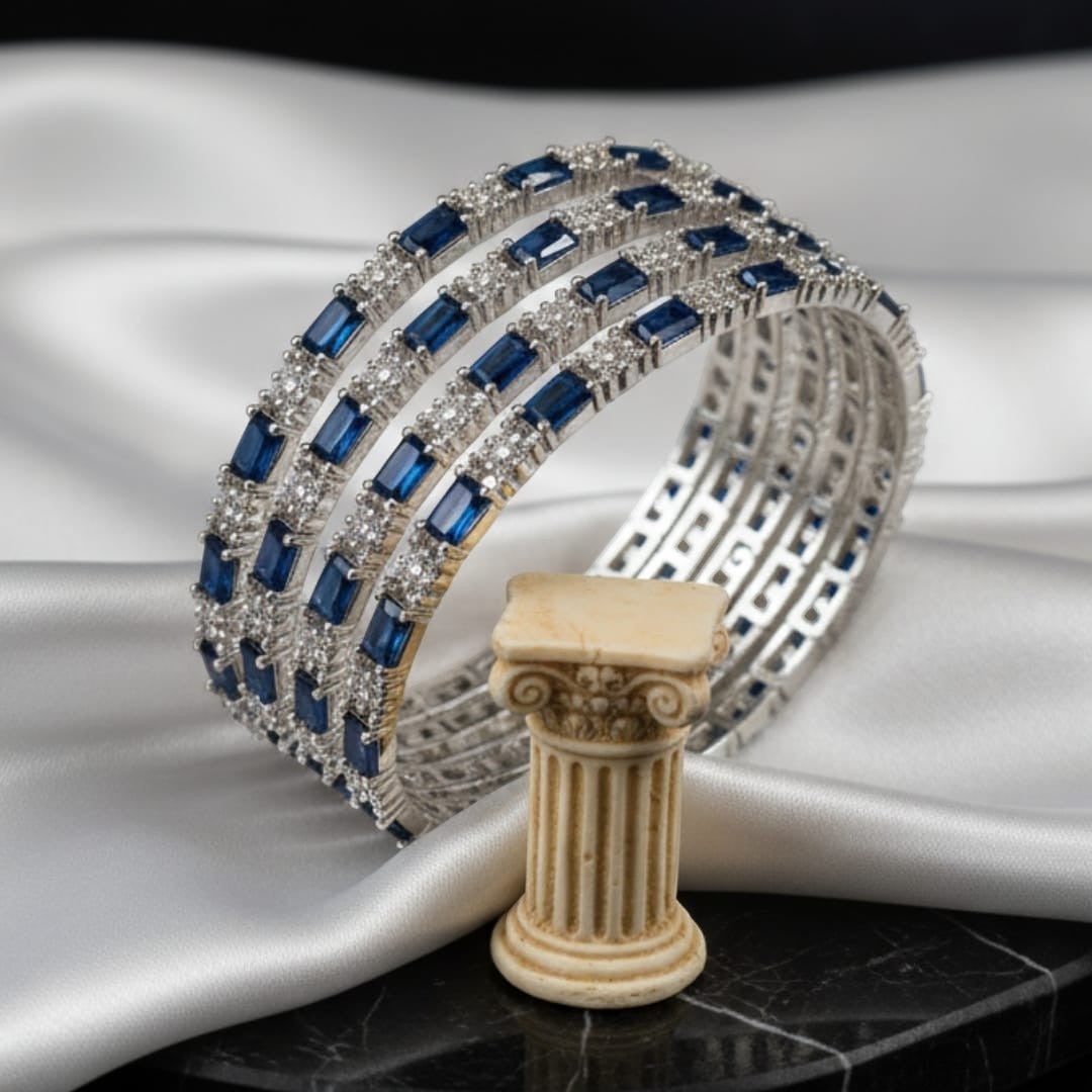 Shinayra by Nakhrali Creation set of 4 blue baguette and round CZ tennis bangles in rhodium silver finish.