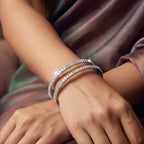 Shinayra by Nakhrali Creation silver-tone bangle set with emerald-cut zircon stones, worn on a woman's wrist.