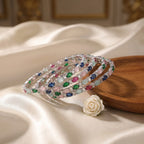 Shinayra by Nakhrali Creation Multicolour Oval CZ Bangle Set with green, blue, pink, aqua, and red stones and white CZ accents.