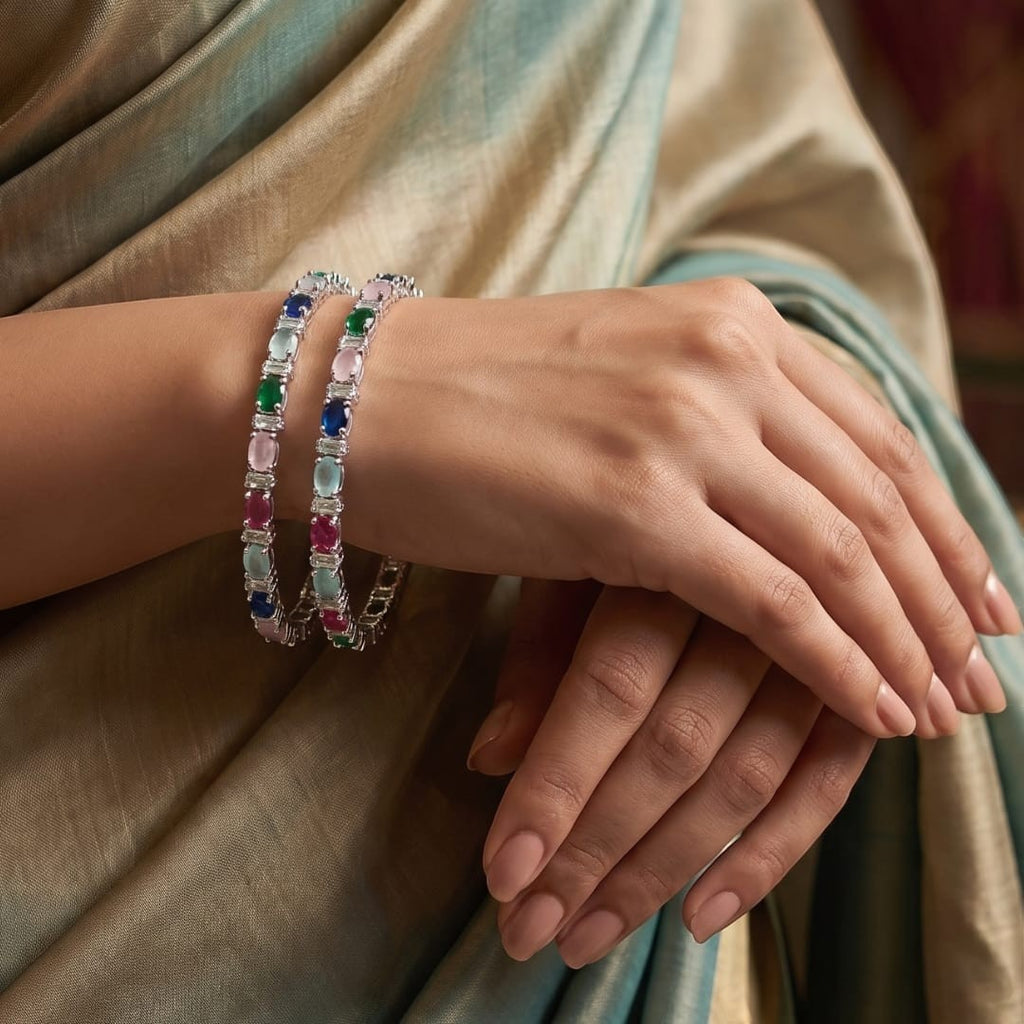 Shinayra by Nakhrali Creation Multicolour Oval CZ Bangle Set with green, blue, pink, aqua, and red stones and white CZ accents on silver-tone.