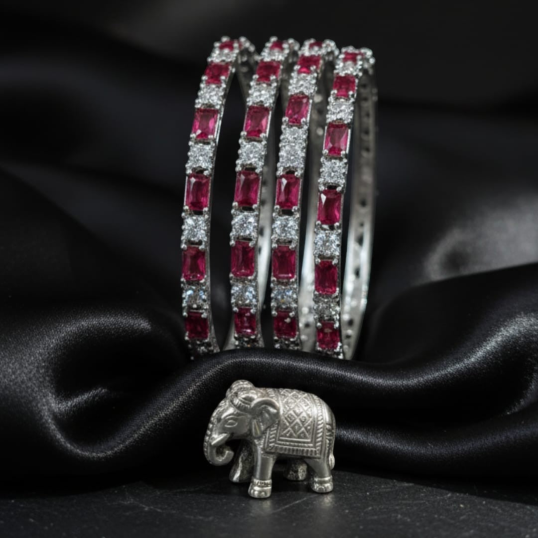 Shinayra by Nakhrali Creation ruby red baguette and round CZ tennis bangles set of 4, rhodium silver finish, bridal essential.