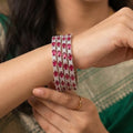Shinayra by Nakhrali Creation ruby red baguette and round CZ tennis bangles, set of 4, rhodium silver finish.